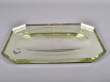 an image of a green glass tray with a knife in it