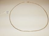 a close up of a necklace on a white surface