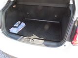 a trunk of a car with a cell phone in it