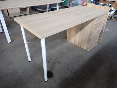 two desks that are sitting in a room