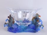 a glass bowl that has a horse and a horse on it