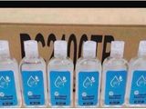 six bottles of water sitting in front of a cardboard box