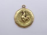 a close up of a gold coin with a bird on it