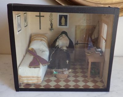 a picture of a doll house with two dolls in it