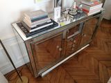 a glass table with books and a lamp on it