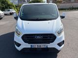 a white ford transit van parked in a parking lot