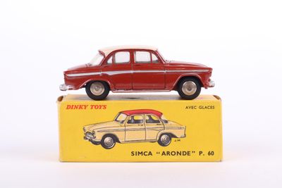 an old red toy car sitting on top of a yellow box