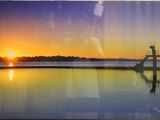 painting of a sunset over a body of water with a pier in the foreground