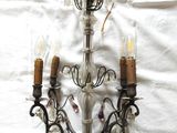 a chandelier that has three lights on it