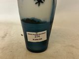a blue and white vase sitting on a table