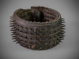 a close up of a metal bracelet with spikes on it