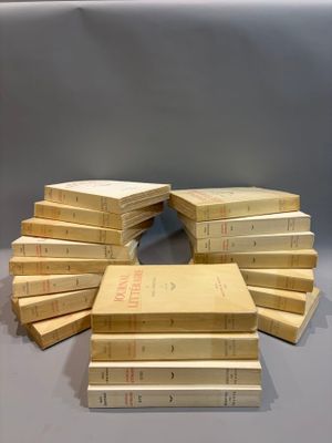several books stacked on top of each other on a table