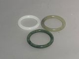 three different colored rings on a white surface