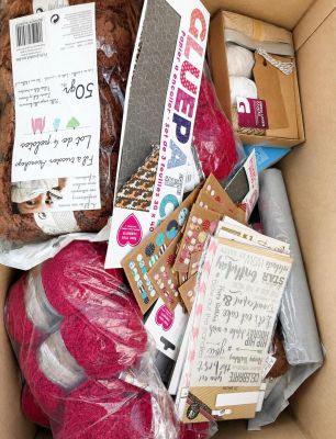 a cardboard box filled with assorted items for sale