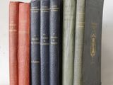 several books are lined up in a row on a table