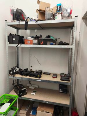 a shelf with many electronics on it in a room