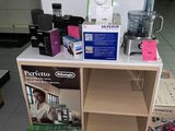 a counter with a blender, a blender, a blender, and other items on it