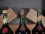 three bottles of wine sitting on a wooden shelf