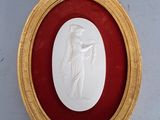 gold framed picture of a woman holding a baby in a red frame
