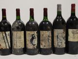 six bottles of wine are lined up in a row on a table