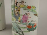 two vases with asian designs on them sitting on a table