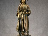 bronze statue of a woman holding a basket of flowers