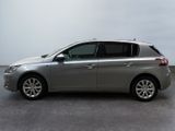 the silver car is parked on the concrete floor in the room