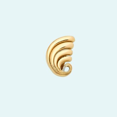 a close up of a gold earring on a white background