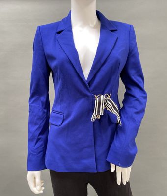 the woman is wearing a blue blazer and black pants