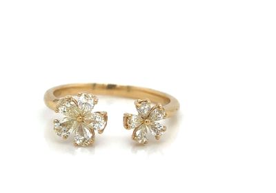 a close up of a gold ring with a flower design on it
