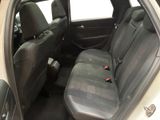 the back seats of a white car with a black seat belt
