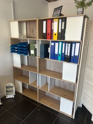 shelves with binders and binders on them in a room