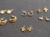 a close up of a bunch of earrings on a table