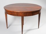 a round dining table with two legs and a wooden top