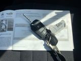 a car key sitting on top of a book with a remote control