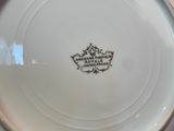 a person holding a plate with a crown on it