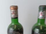 two bottles of wine that are sitting on a table