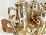 a silver tray with a silver tea set on it