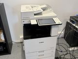 a printer that is sitting on the floor next to a keyboard