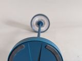 a blue clock that is sitting on a white table