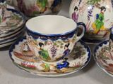 a lot of cups and saucers sitting on a table