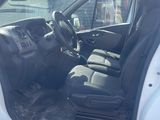 the interior of a car with the door open and the driver ' s seat down