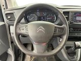the interior of a car with a steering wheel and dashboard controls