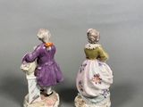 pair of figurines of two women dressed in victorian clothing
