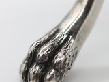 a close up of a metal object on a white surface
