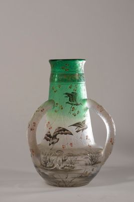 a green glass vase with a picture of birds on it