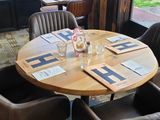 tables and chairs in a restaurant with a view of the street
