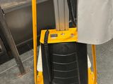 a yellow cart with a bag on top of it