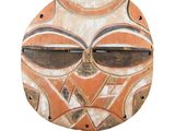 an image of a wooden mask on a stand on a white background