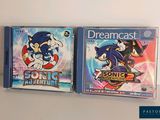 two cds that are sitting on a shelf